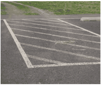 Mulch, dirt, and grass debris deposited on pervious pavement from adjacent landscaping runoff
